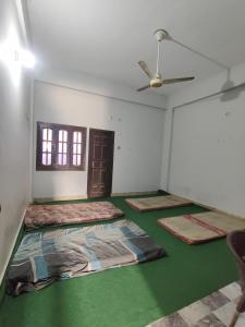 an empty room with four mattresses on the floor at Dream Hostel Sukkur in Sukkur