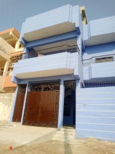 a blue building with a gate and a door at Dream Hostel Sukkur in Sukkur