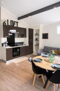 a living room with a table and a kitchen at Loft, Studio and Love Rooms in Bourg-Saint-Christophe