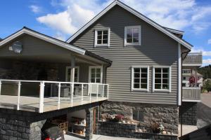a house with a porch and a balcony at Viken Holiday Home in Viksdalen