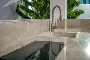 a sink in a kitchen with a counter top at Palm Residence Vacation Villa in Nungwi +53 photos