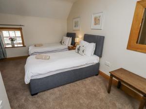 a hotel room with two beds and a table at High Hemmel House in Embleton +43 photos
