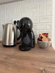 a coffee maker on a counter with a bowl of food at Panonski Mornar in Palić