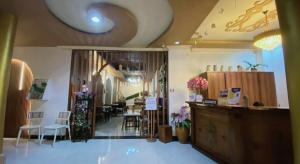 a salon with a waiting room with tables and chairs at Hotel Raudah Kapuas in Kualakapuas