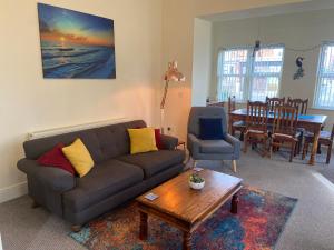 a living room with a couch and a table at The Shelbourne in Southport