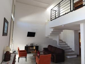 a living room with a couch and a staircase at Casa Lanre in Huichapan