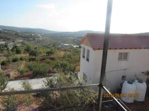 a white house with a view of a valley at اكواخ الملول عجلون 2 in Ajloun