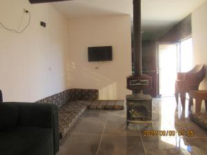 a living room with a couch and a wood stove at اكواخ الملول عجلون 2 in Ajloun