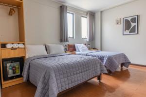a bedroom with two beds and a fireplace in it at San Miguel Awanka Hotel in Lima