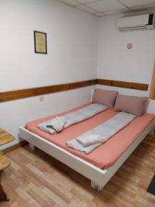 a bed in a room with avertisementatronatronstrationstrationstration at Скай Румс -3 in Sofia