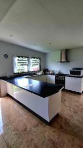 a kitchen with a black and white counter top at MJA's Retreat in Arorangi
