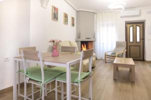 a living room with a table and chairs and a fireplace at Casa Abilio Rodenas in Alborea