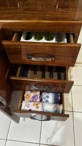 a wooden drawer with a bunch of wine bottles at Casas de Praia do Coqueiro com AR e varandas in Luis Correia +12 photos