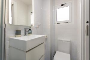 a white bathroom with a sink and a toilet at Casa Abilio Rodenas in Alborea +10 photos