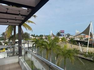 a balcony with a view of a marina with boats at Luxury loft with pool and beautiful view in Tampico