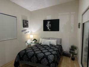 a bedroom with a bed with a black and white blanket at Luxury loft with pool and beautiful view in Tampico +62 photos