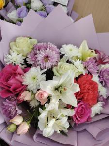 a bouquet of colorful flowers in a box at استوديو 104 in Tabuk +1 photo