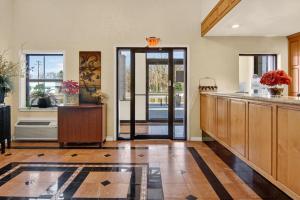 a kitchen with wooden cabinets and a counter top at 12 Oaks Hotel in Tyler