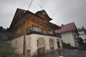 a large building with a balcony on top of it at Summit View Wisła in Wisła