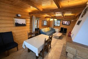 a living room with a table and a couch at Summit View Wisła in Wisła
