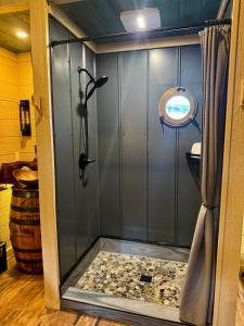 a shower stall in a bathroom with a toilet at "Morning Wood" Luxury Treehouse Retreat Near Dollywood & Pigeon Forge in Sevierville +36 photos