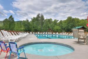 a swimming pool with chairs and a bunch ofitures at Little Pine Lodge a Smokies Hideaway - 1 mi to GSMNP - King Suite & Loft, Fireplace, Hot Tub & BEARS! in Sevierville