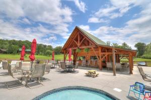 a pavilion with a table and chairs next to a pool at Little Pine Lodge a Smokies Hideaway - 1 mi to GSMNP - King Suite & Loft, Fireplace, Hot Tub & BEARS! in Sevierville
