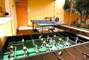 a ping pong table in a backyard with a ping pongetitive at White Lake Holiday House in Elafonisi