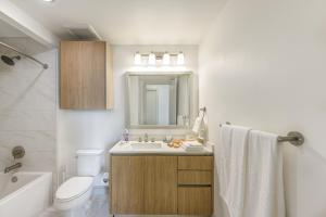 a bathroom with a sink and a toilet and a mirror at Hanover BLVD Place in Houston +38 photos