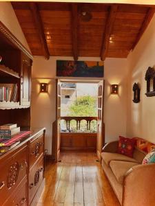 a living room with a couch and a window at Picaflor Tambo Guest House in Ollantaytambo