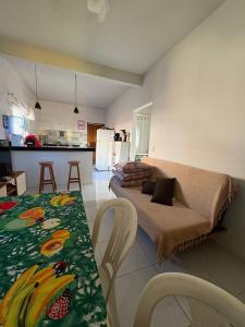 a living room with a couch and a table at CasadaKassia in Itapemirim
