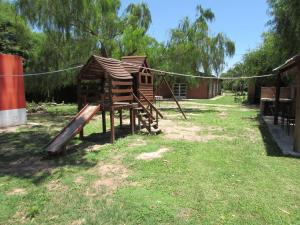 a wooden playground with a house and a rope at Chalet 1 Dormitorio Kallpa in Santiago del Estero