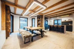 a dining room with a wooden table and benches at Fox Chalet in Molidu