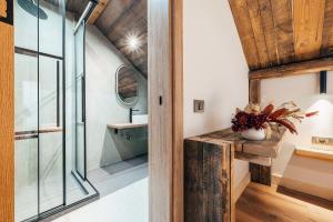 a bathroom with a glass door and a sink at Fox Chalet in Molidu +41 photos