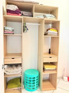 a wooden closet with wooden shelves at Bungalow Pamatai Sky in Faaa