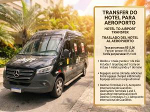 a van parked on a street next to a sign at Airport Gru Flats in Guarulhos