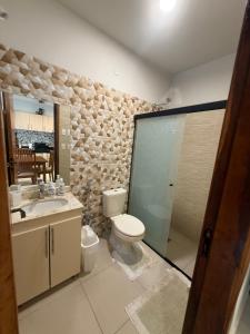 a bathroom with a toilet and a sink at Residencia Pura Vida in Capiatá