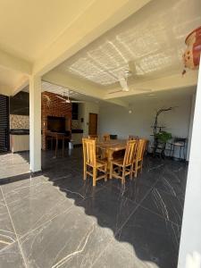 a dining room with a table and chairs at Residencia Pura Vida in Capiatá +11 photos