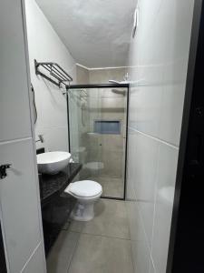 a bathroom with a shower and a toilet and a sink at Book a bed Jacumã in Conde