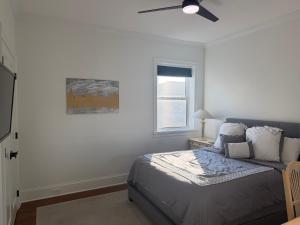 a bedroom with a bed and a ceiling fan at The Lyons' Den in Chicago