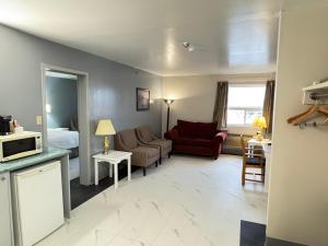 a living room with a couch and a microwave at Burntwood Hotel and Restaurant in Thompson