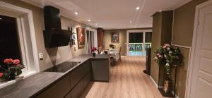 a large kitchen with a counter and a living room at Hardanger Fjordblikk in Syreflot