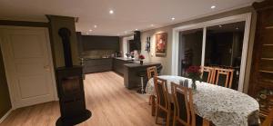 a kitchen and dining room with a table and a table and chairs at Hardanger Fjordblikk in Syreflot