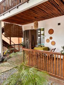 a porch with a wooden deck with a table at Villa Sairé in Alter do Chao