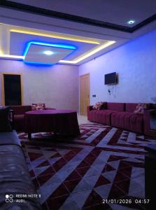 a living room with couches and a blue light at إقامة حسن in Fez