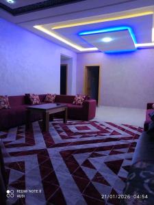 a living room with a couch and a table at إقامة حسن in Fez