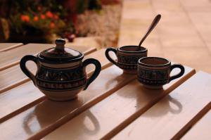 three coffee cups sitting on a wooden table at Nebojsega b&b in Santa Croce Mare