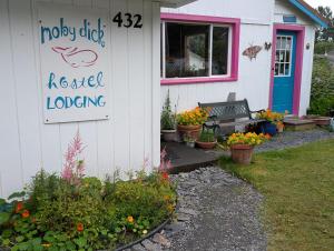a house with a sign that reads rosieoked loading at MobyDick Hostel in Seward