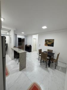 a living room with a table and chairs at Apartamento Loretto in Espirito Santo Do Pinhal