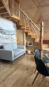 a living room with a couch and a glass table at Villa Santa Rita in Cobquecura